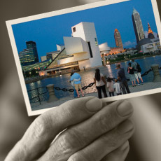 Detail of 2009 Report to Community Cover. Elderly hand holding color photograph of downtown Cleveland.