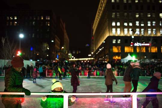 People ice skating at night on Cleveland Foundation Skating Rink on Public Square