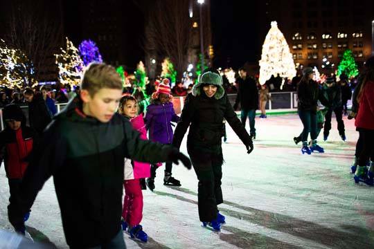 Youth ice skating at night on Cleveland Foundation Skating Rink in Public Square