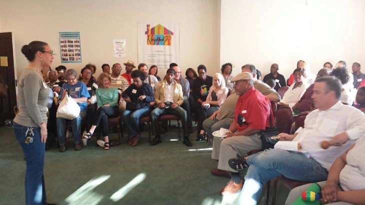 A group of residents seated around the room during a Neighborhood Connections meeting