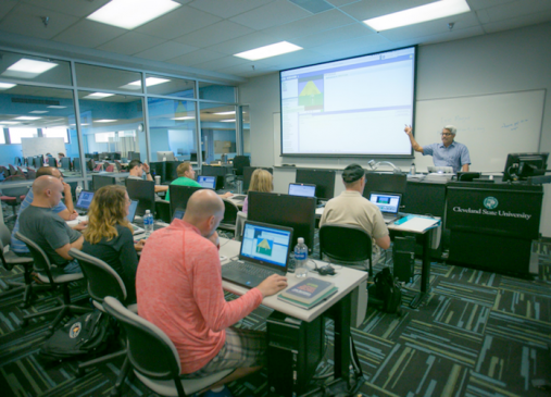 Students listen to professor in computer science class