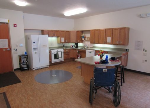 Image of MAHO model unit shows a kitchen space and wheelchair