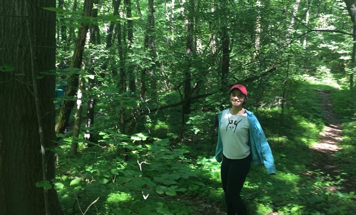 Maritess is pictured walking in the woods