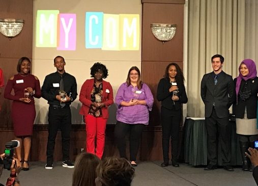 The 2017 MyCom Youth Voice Awards Youth Category winners stand onstage with their awards