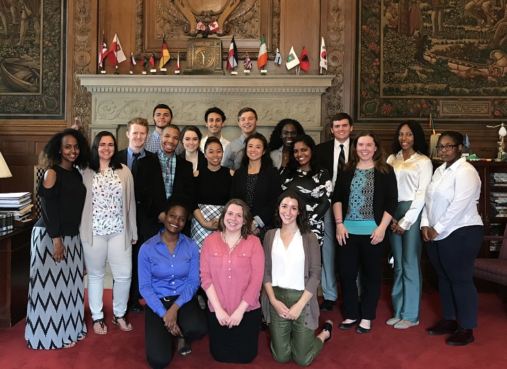 2017 Cleveland Foundation Summer Interns stand in front of fireplace in Mayor's office