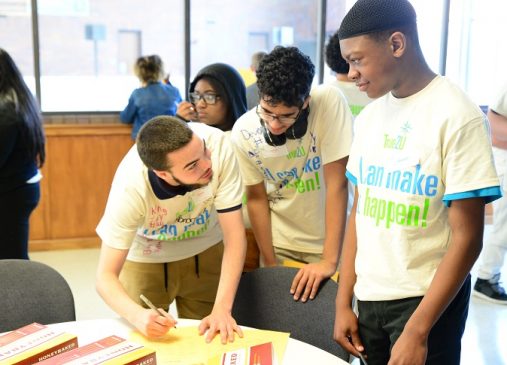 Three eight grade CMSD students wearing True2U shirts work together on an exercise