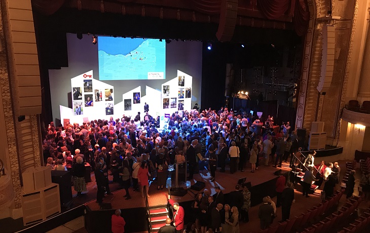 crowd pictured onstage at 2018 annual meeting community reception