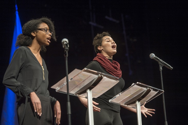 Young poets pictured on stage during performance 