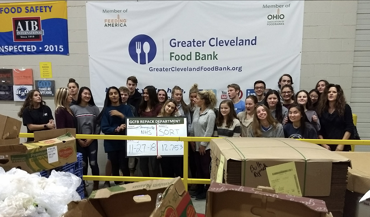 Strongsville High School National Honor Society students gather at the Greater Cleveland Food Bank to distribute meals in the region.  