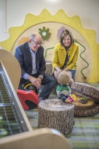 JoAnn and Bob Glick sit with a child in the Children's Museum of Cleveland 