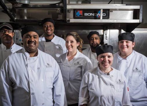 A group of Bloom Bakery chefs stand in kitchen