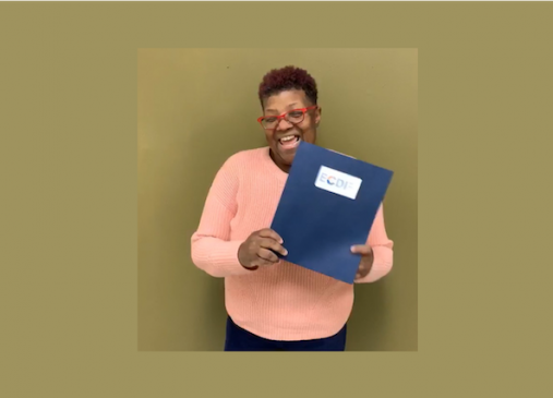 Michelle Madison poses with a Womens Business Center Folder