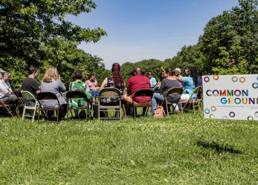 A group of people sitting outside at a Common Ground conversation