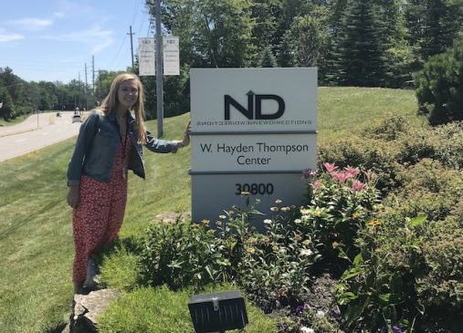 Agnes stands next to New Directions sign