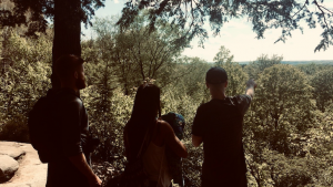 Three people face wooded overlook in Cuyahoga Valley National Park