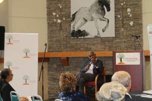 Robert P Madison speaks to crowd at event