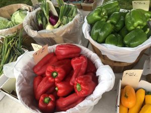 baskets of veggies at the farmers market