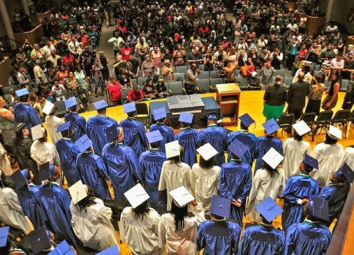 A group of students on stage at graduation