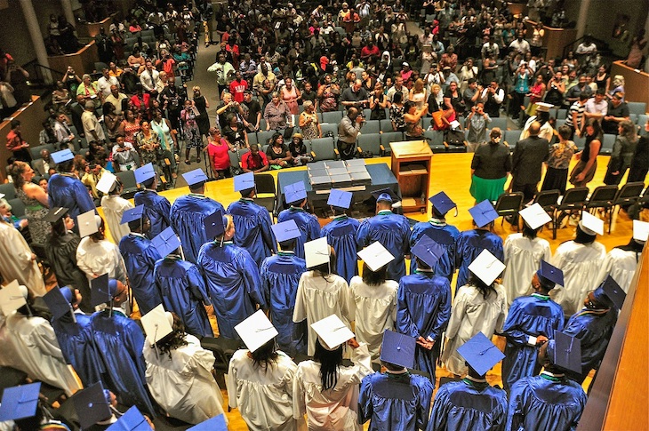 A group of students on stage at graduation