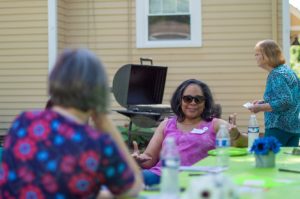 two women sit and talk to each other