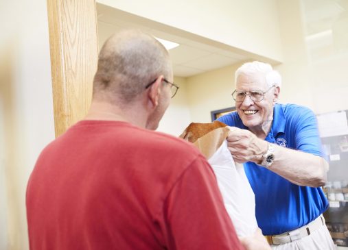 Food Rescue volunteer delivering bag of food