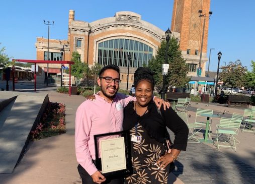 Christopher and a woman stand outside a building in Cleveland