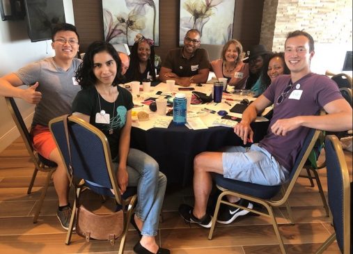 A group of people sit around a table