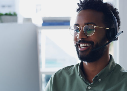 Man with headset in front of computer