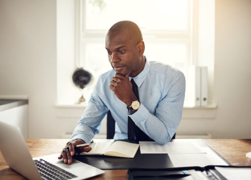 Man sits in front of laptop