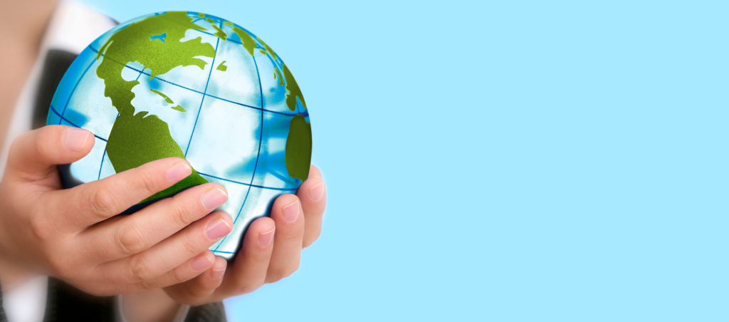 Image of person holding small globe