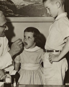 A young girl gets polio vaccine