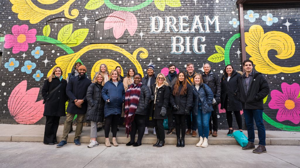 Members of the 2022 Foundations for Philanthropy cohort pose in front of a mural that says "dream big"