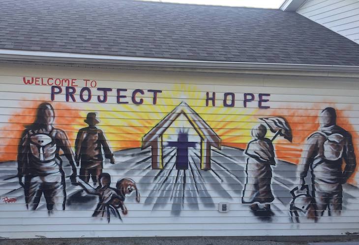 A mural on the side of a building says Project Hope
