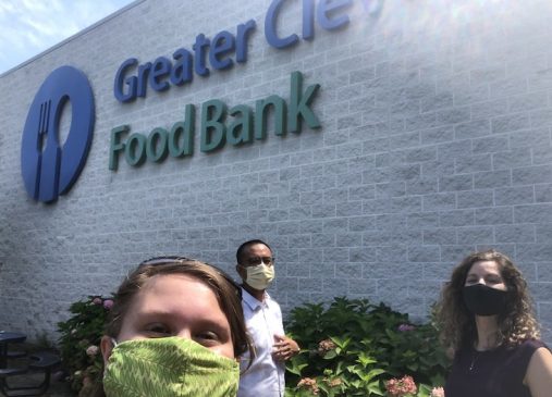 Jenna Thomas and two others in front of Cleveland Food Bank building