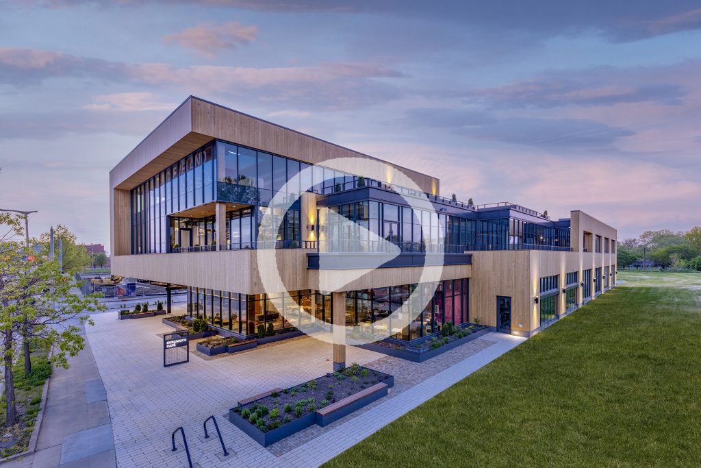 SE dusk view of HQ w/video play button