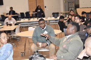 A group of people sit in a room talking