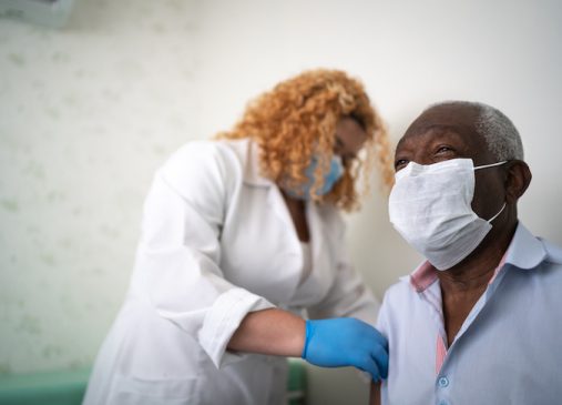 Nurse applying vaccine on patient's arm
