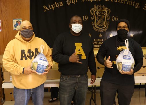 Photo of three members of the Cleveland chapter of Alpha Phi Alpha at a food distribution event