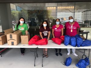 Four volunteers assemble COVID care kits