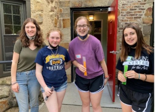 Four girls stand in front of a building