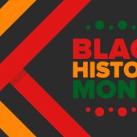 Black history month graphic with red, orange and green text on black background