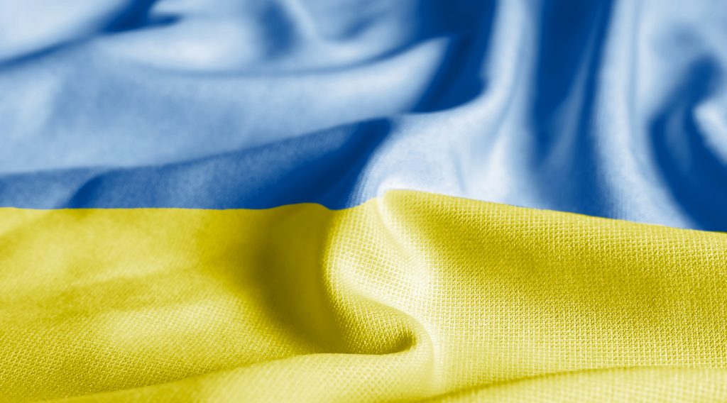 Close up of the Ukraine flag on a ruffled mesh fabric.