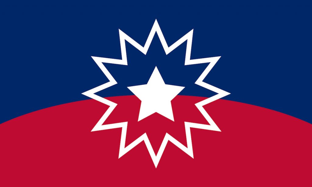 The Juneteenth flag where the upper half is blue and lower half is red. Colors are divided by a horizontal arch. In the center is a white star which is outlined.
