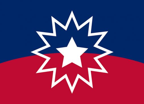 The Juneteenth flag where the upper half is blue and lower half is red. Colors are divided by a horizontal arch. In the center is a white star which is outlined.