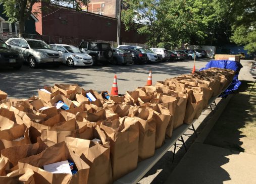 Food bags lined up on a table outside