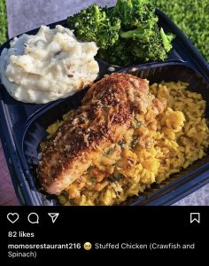 A carryout box with chicken, rice, mashed potatoes and broccoli from Momo's restaurant