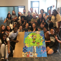 Group of summer interns pose with art project