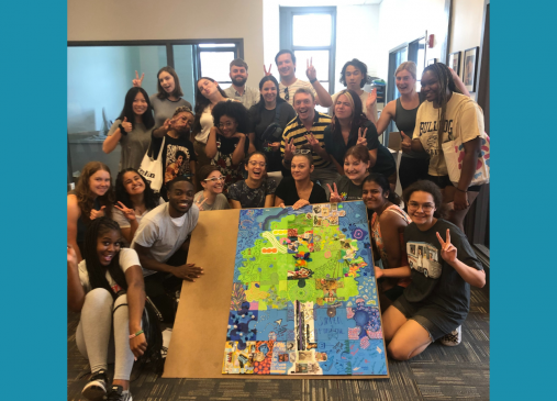 Group of summer interns pose with art project