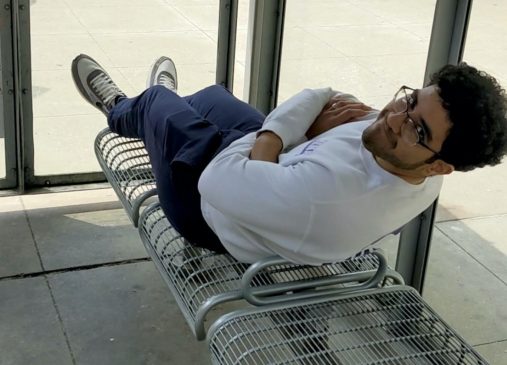 Photo of Mohamed Manaa lying on bench